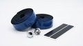 Premium deep blue bicycle handlebar tape rolls with a textured hexagon honeycomb pattern, shown next to two silver chrome bar end plugs and black finishing adhesive strips on a clean white background.