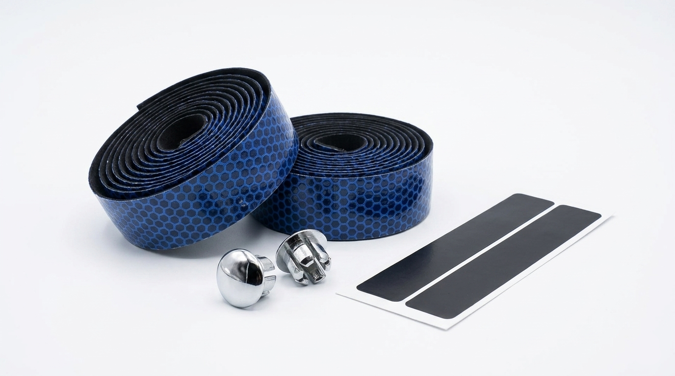 Premium deep blue bicycle handlebar tape rolls with a textured hexagon honeycomb pattern, shown next to two silver chrome bar end plugs and black finishing adhesive strips on a clean white background.