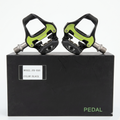 A matching pair of left and right Promend PD-R95 black road cycling clipless pedals with bright lime-green accent plates, resting on top of their original matte black retail packaging box labeled with the model name.