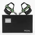 A pair of left and right Promend PD-R97TI metallic silver aluminum road cycling clipless pedals, sitting on top of their original black retail box displaying the model name and titanium axle badge.