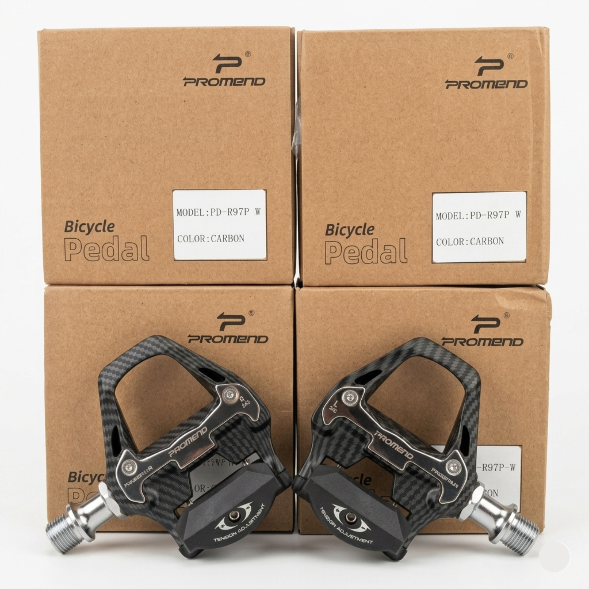 Front-facing view of a pair of black Promend PD-R97P W road bicycle pedals with a carbon fiber weave pattern, resting symmetrically against four brown retail boxes.