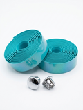 Two rolls of premium celeste teal bicycle handlebar tape displayed alongside two metallic chrome handlebar end plugs on a clean white background