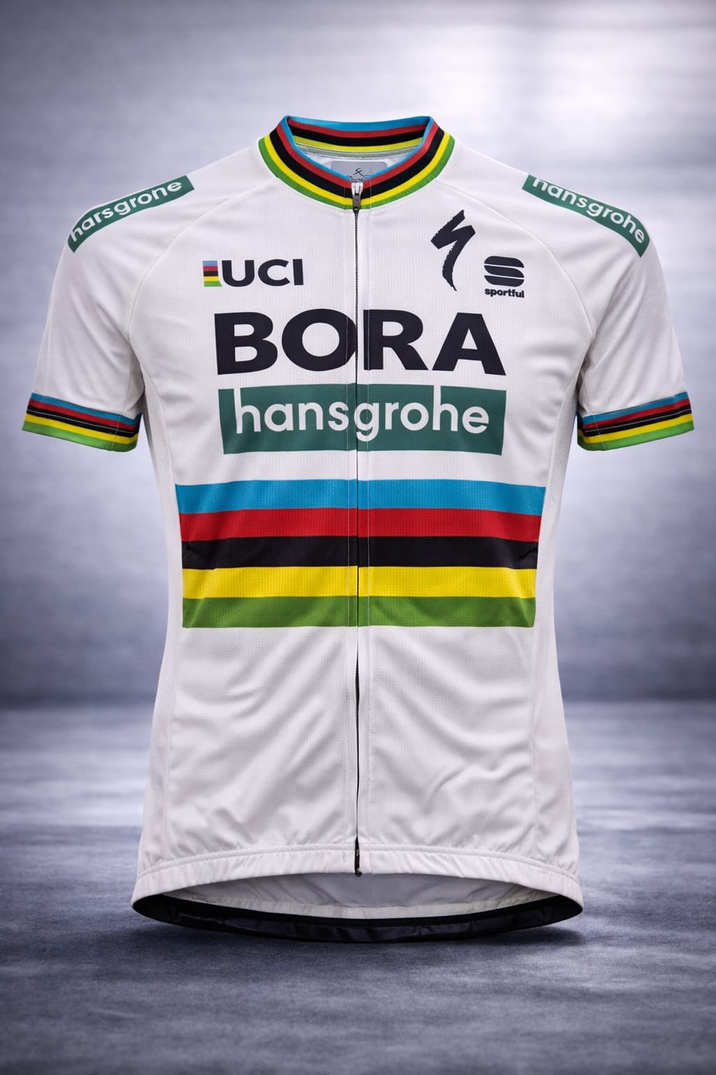 Front view of the white Bora-Hansgrohe World Champion edition short sleeve cycling jersey, featuring the full front zipper, UCI logo, and colorful rainbow stripes across the chest.