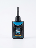 A 50ml black bottle of WATT Dry Lube Race Edition with a light blue and black label, featuring a gear icon, a precision applicator nozzle, and standing upright against a solid white background.