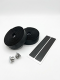 Premium black bicycle handlebar tape rolls with a breathable micro-perforated texture as shown in image, displayed next to two metallic chrome bar end plugs and two black adhesive finishing strips on a clean white background.