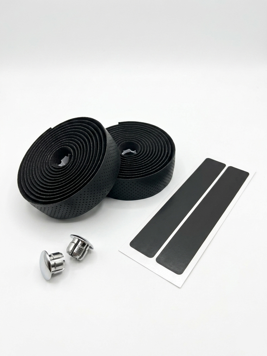 Premium black bicycle handlebar tape rolls with a breathable micro-perforated texture as shown in image, displayed next to two metallic chrome bar end plugs and two black adhesive finishing strips on a clean white background.