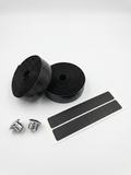 Premium classic black bicycle handlebar tape rolls with a textured hexagon honeycomb surface pattern, paired with two shiny chrome bar end plugs and black adhesive finishing strips on a clean white background.