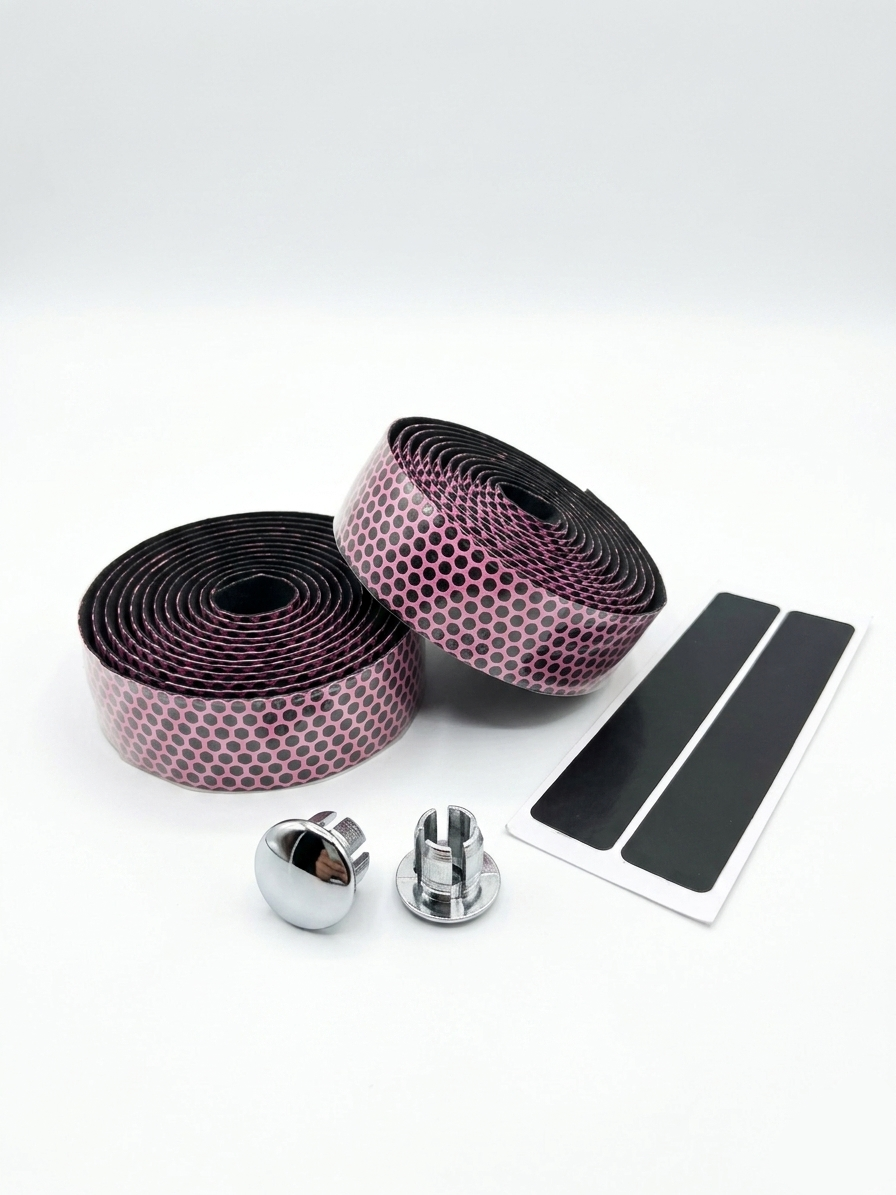 Premium vibrant pink bicycle handlebar tape rolls with a textured black and pink hexagon honeycomb pattern as shown in image, displayed next to two reflective chrome bar end plugs and two black adhesive finishing strips on a clean white background.