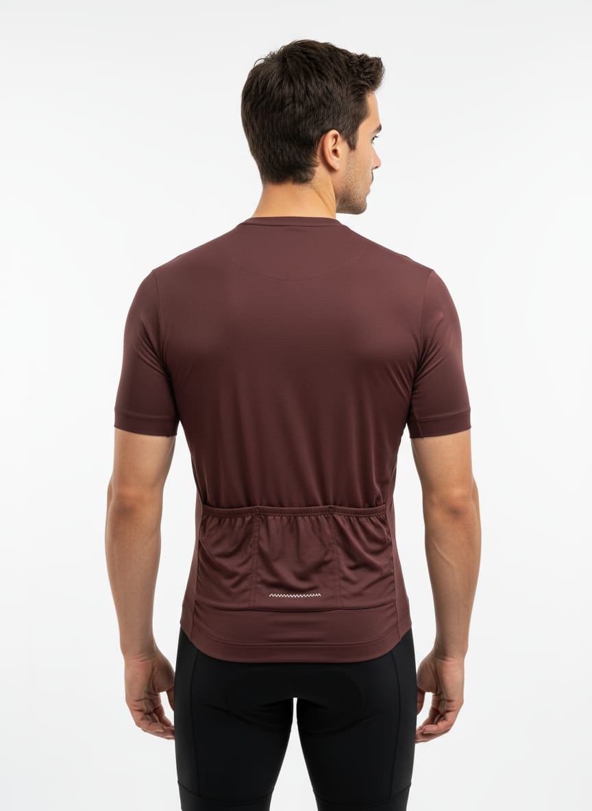 Rear view of a male model wearing a maroon Reeck race fit cycling jersey, highlighting the three elasticated back cargo pockets and a small reflective safety strip.