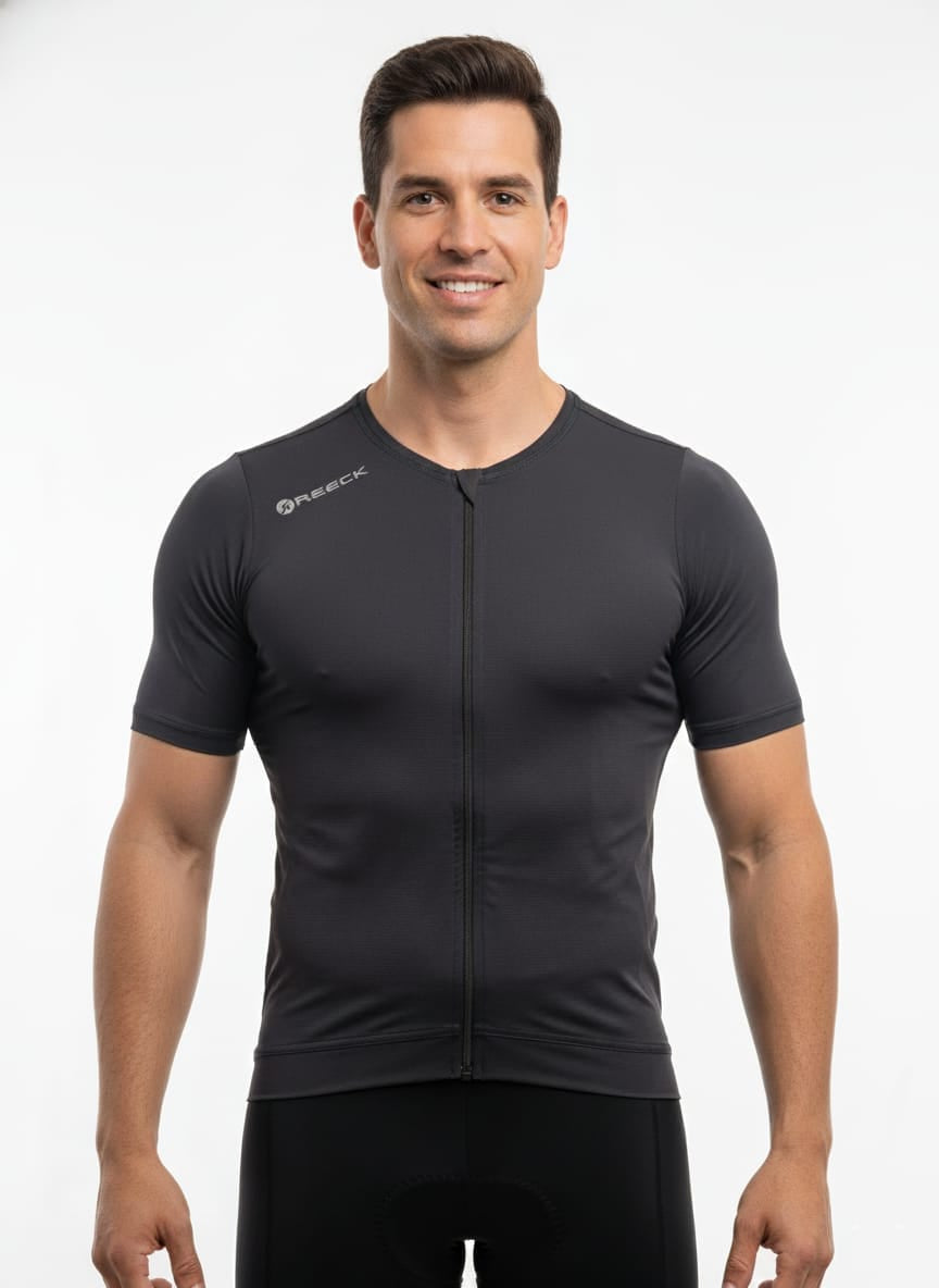 Front studio view of a male model wearing a tight compression-fit, dark blue Reeck short sleeve cycling jersey with a full-length front zipper and a white logo on the shoulder.
