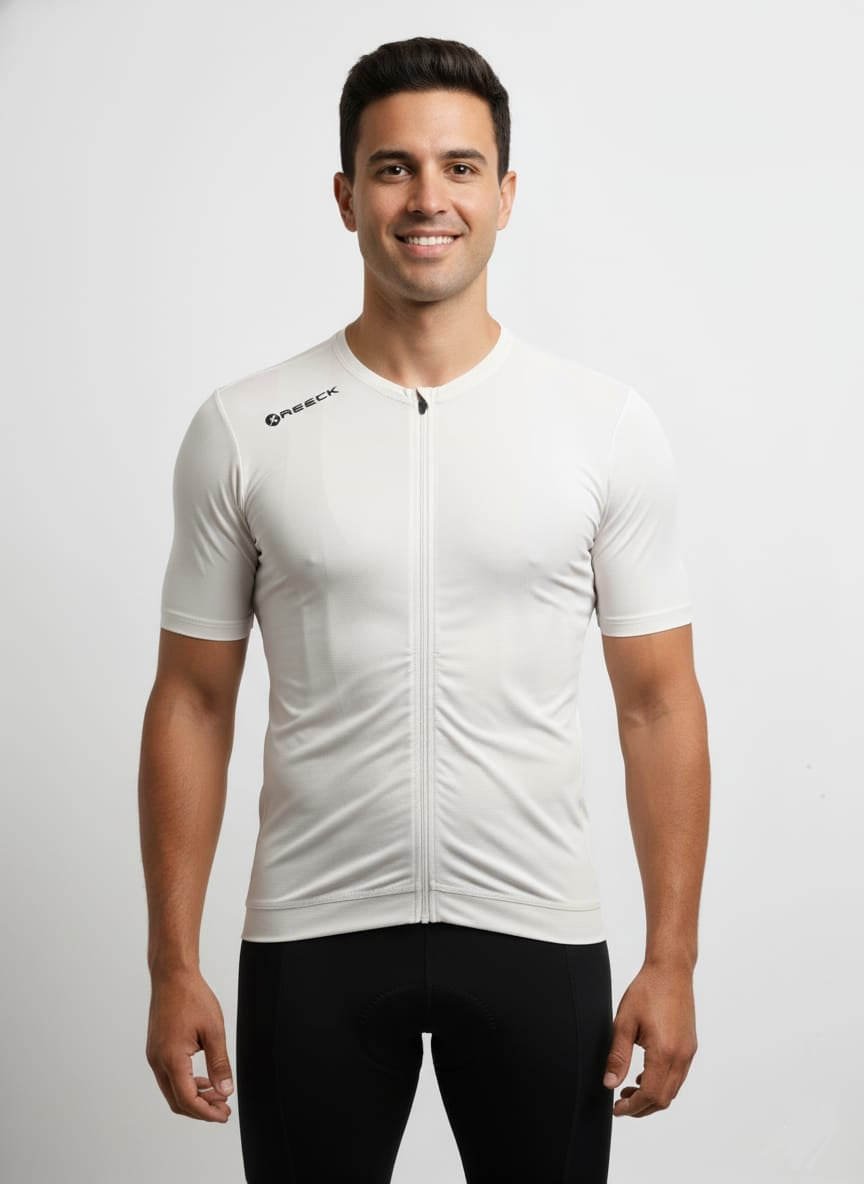 Front studio view of a male model wearing a tight compression-fit, classic white Reeck short sleeve cycling jersey with a full-length white zipper and a black brand logo on the right shoulder.