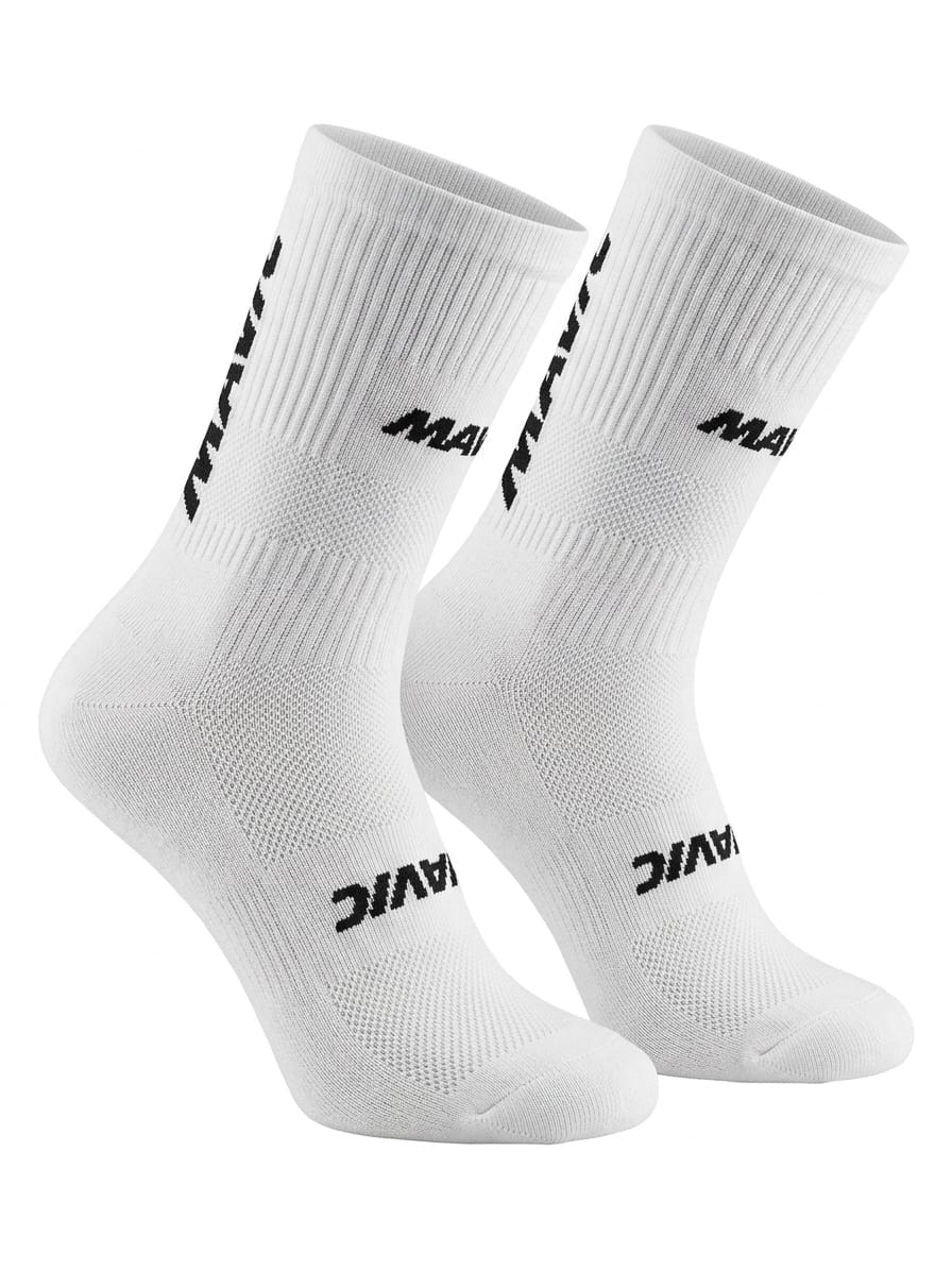 Pair of Mavic performance crew-height cycling socks in crisp classic white, featuring bold black text branding stacked vertically along the side of the upper cuff and across the instep, displayed against a plain background.
