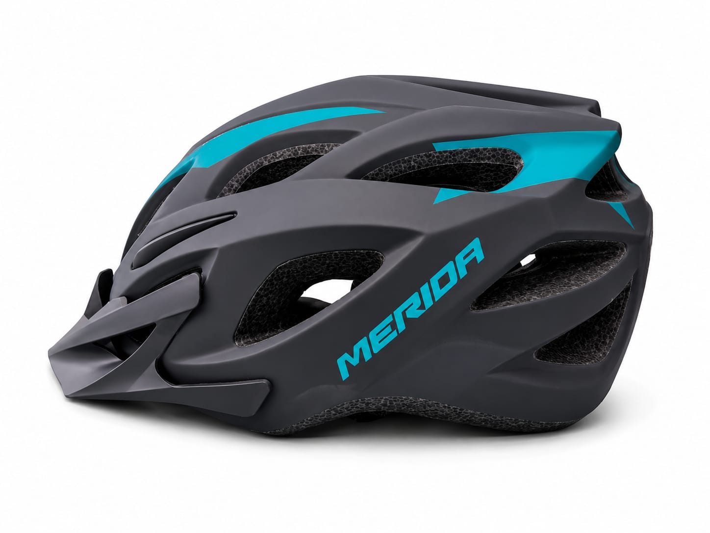 A side profile view of a MERIDA cycling helmet featuring a matte dark grey outer shell with vibrant teal structural accents and the Merida brand name printed on the side, including a matching removable front visor and a textured black EPS foam liner with integrated ventilation channels, set against a clean white background