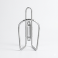 Front view of a sleek, matt silver Merida aluminum alloy bicycle water bottle cage with a clean tubular design and slotted mounting spine, isolated on a plain white background.