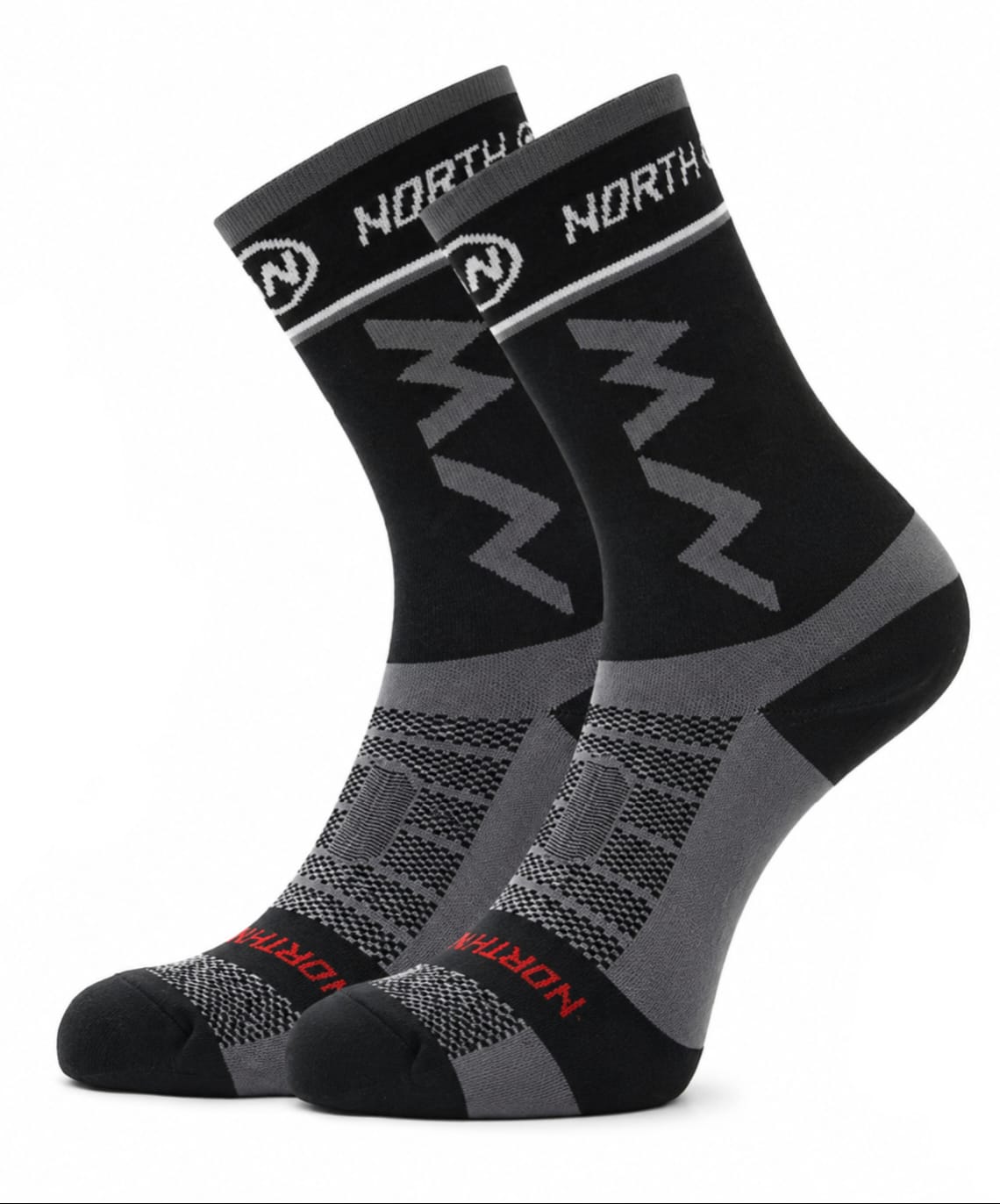 A pair of NORTHWAVE performance crew cycling socks in a black and grey colorway with a subtle red accent name on the toe, showcasing geometric NW branding on the upper cuff and a textured mesh design over the foot, displayed upright against a clean white background