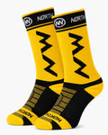 A pair of NORTHWAVE performance crew cycling socks in a solid yellow and black colorway, showcasing geometric NW branding on the upper cuff and a textured mesh design over the foot, displayed upright against a clean background