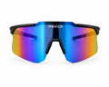 Front view of REECK Velocity half-frame sports sunglasses featuring a matte black top frame and a rimless-bottom iridescent shield lens shifting from blue to purple and gold.