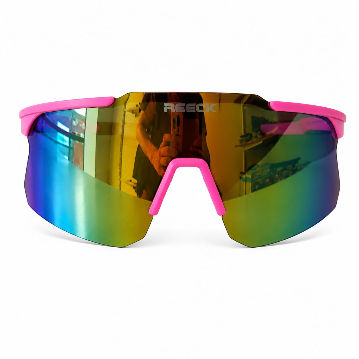 Front view of REECK Velocity half-frame sports sunglasses featuring a bright pink top frame, a pink nose bridge, and a wide rimless-bottom shield lens with a highly reflective gold and teal green mirror finish.