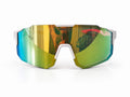 Front view of REECK Prism half-frame sports sunglasses featuring white frame accents and an angular, rimless-bottom shield lens shifting from bright gold to jade green and blue.