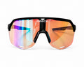Front view of REECK AeroShield performance sports sunglasses with a black frame and an oversized, iridescent crimson and orange mirrored shield lens with anti-fog vents.
