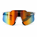 Front view of REECK Velocity half-frame sports sunglasses featuring an arctic white top frame, white nose piece, and an expansive rimless-bottom shield lens with a highly reflective crimson orange and cyan blue mirror coating.