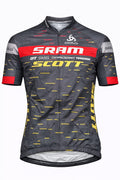 Front view of a pro team short sleeve cycling jersey in dark gray with a red chest band, yellow Scott logo, and horizontal yellow dashed line patterns.